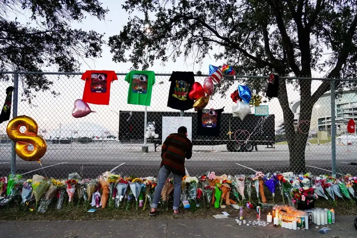 A visitor writes a note at a memorial outside of the canceled Astroworld festival at NRG Park on Nov. 7, 2021 in Houston.