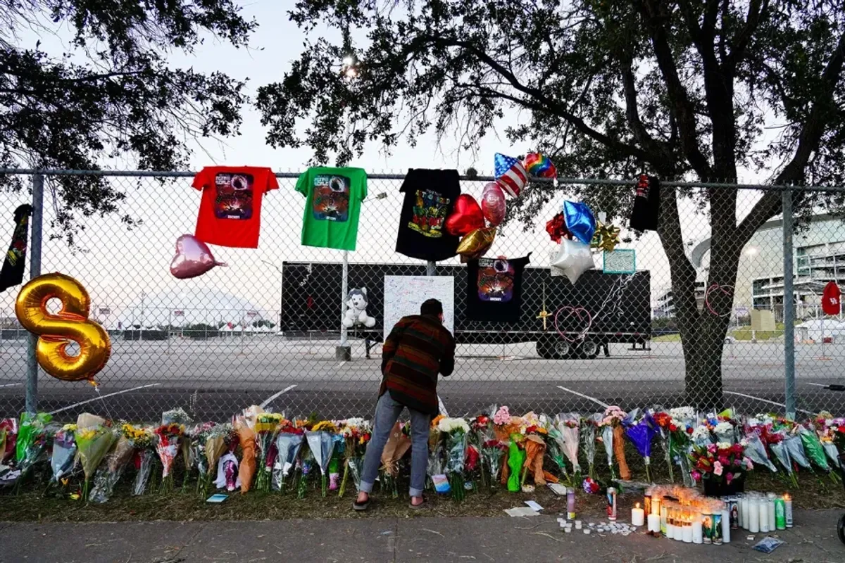 A visitor writes a note at a memorial outside of the canceled Astroworld festival at NRG Park on Nov. 7, 2021 in Houston. 