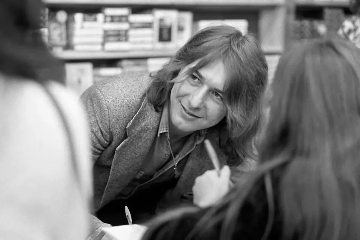 Bad Company guitarist Mick Ralphs signs autographs at a Bad Company instore appearance at Peaches Records on March 31, 1976 in Atlanta.