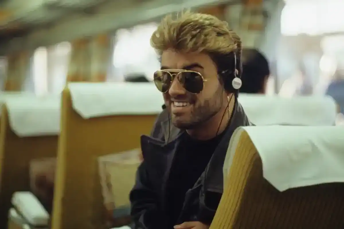 George Michael pictured listening to a Walkman on a bullet train during the Japanese leg of his Faith World Tour in February 1988.