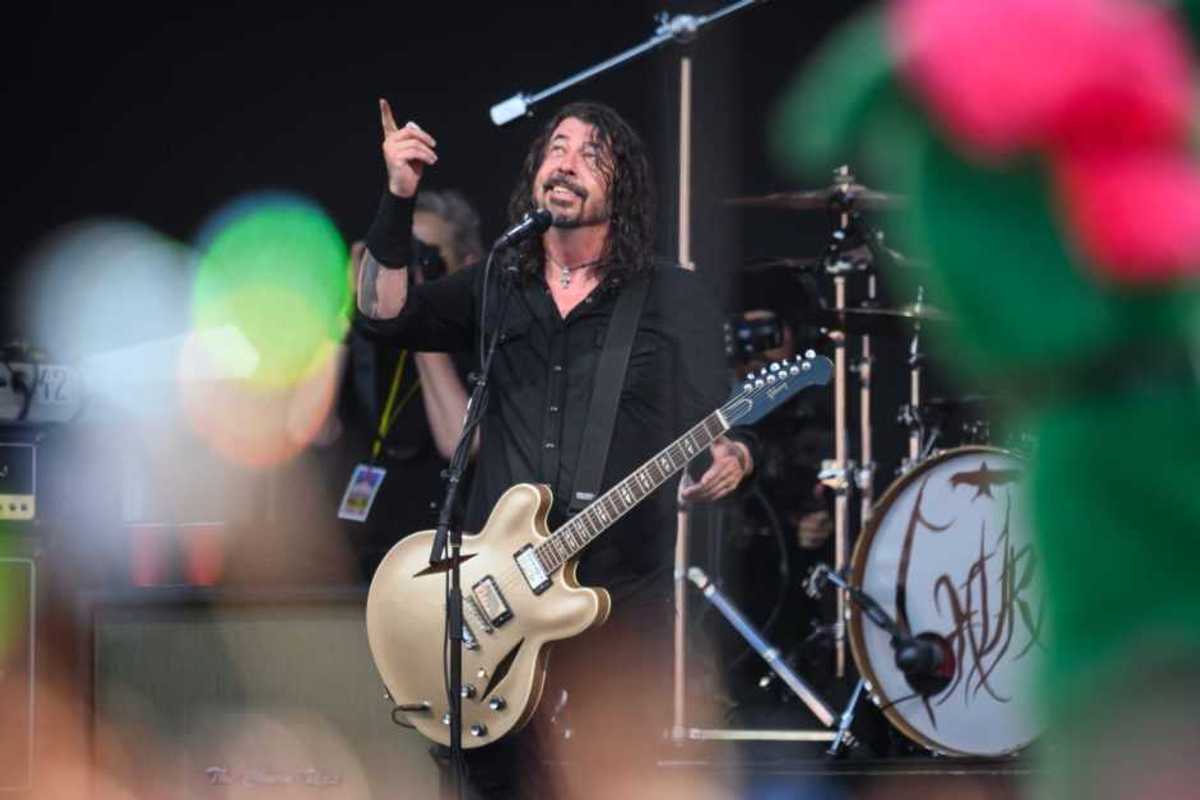 GLASTONBURY, ENGLAND - JUNE 23: Dave Grohl of the Foo Fighters gestures to the sky after referring to the late drummer Taylor Hawkins as the band perform on the Pyramid Stage on Day 3 of Glastonbury Festival 2023 on June 23, 2023 in Glastonbury, England. The Glastonbury Festival of Performing Arts sees musicians, performers and artists come together for three days of live entertainment.