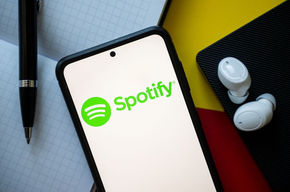 In this photo illustration a Spotify logo seen displayed on a smartphone.