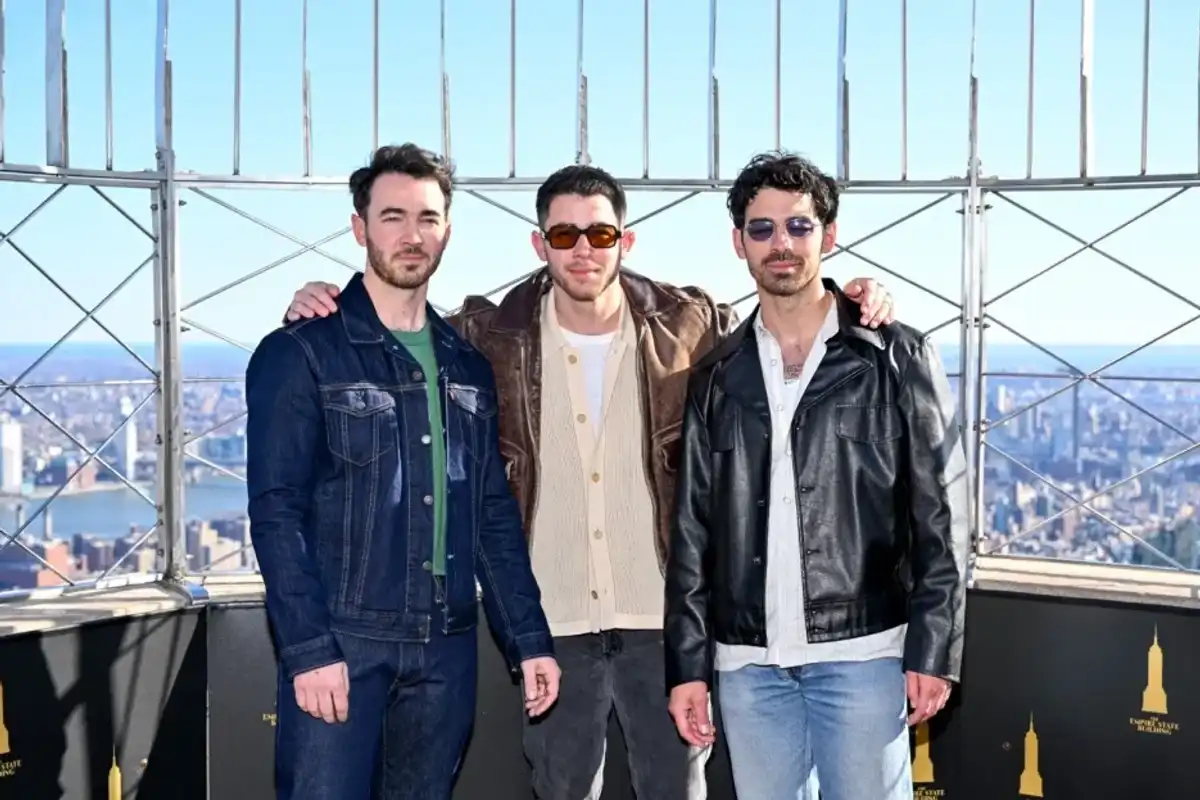 Kevin Jonas, Nick Jonas and Joe Jonas light the Empire State Building to celebrate 20 tears and to launch JONASCON Weekend at The Empire State Building on March 21, 2025 in New York.
