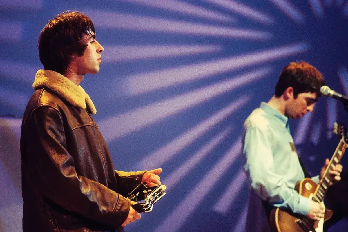 Liam Gallagher and Noel Gallagher of Oasis performing on UK TV show in 1995.
