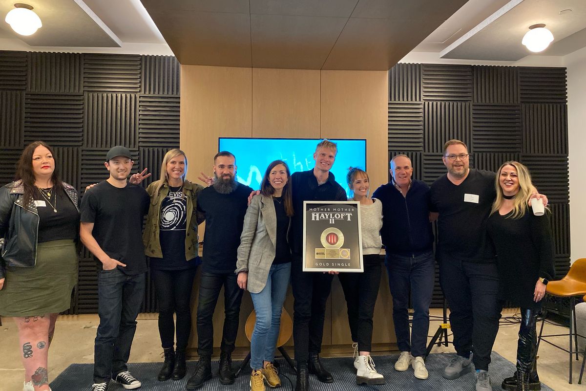 Mother Mother receiving a recent gold single for their song 'Hayloft II'