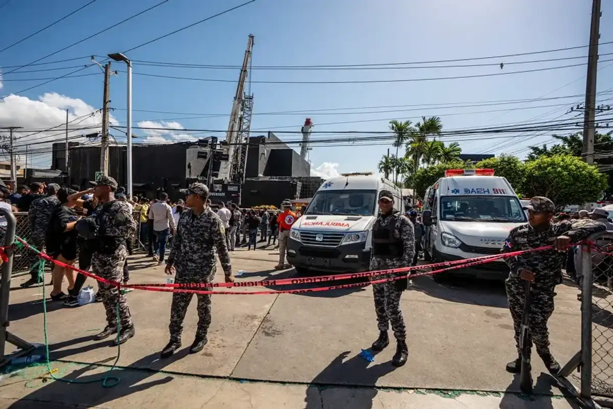 National Police members stand guard outside of the Jet Set nightclub following the collapse of its roof, in Santo Domingo, on April 8, 2025.