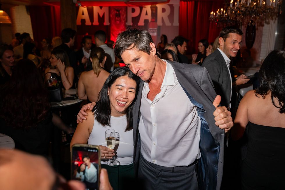 Simon Rex poses for pictures with a guest at TIFF pre-premiere party for Easy's Waltz during the 2025 Toronto International Film Festival at Campari's Cinema Center.