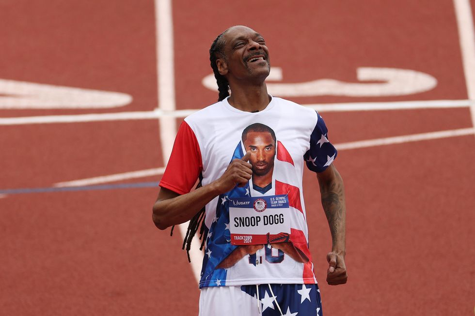 Snoop Dogg runs on the track with a custom bib number on Day Three 2024 U.S. Olympic Team Trials Track & Field at Hayward Field on June 23, 2024 in Eugene, Oregon.