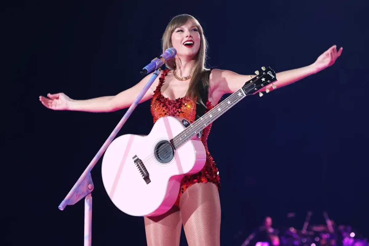 Taylor Swift Fan Wears Cape Highlighting Her Billboard Hot 100 Record to Paris Eras Show