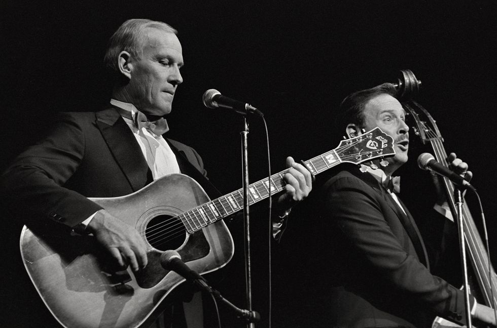Tom and Dick Smothers perform at the Cheyenne Civic Center on Oct. 1, 1987 in Cheyenne, Wyoming.